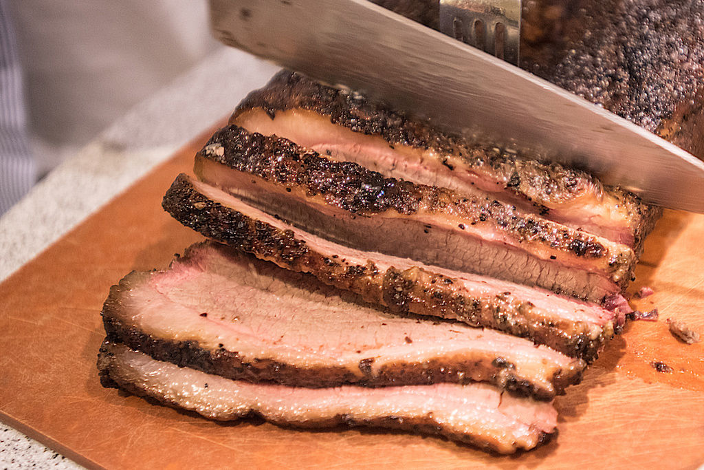 Texas brisket sliced on chopping block